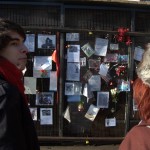 Tourists view tributes to Ianto Jones outside the Torchwood Hub