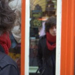 A tourist admires himself in a mirror in an arcade