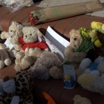 Cuddly toys and notes left by locals in memory of the baby boy